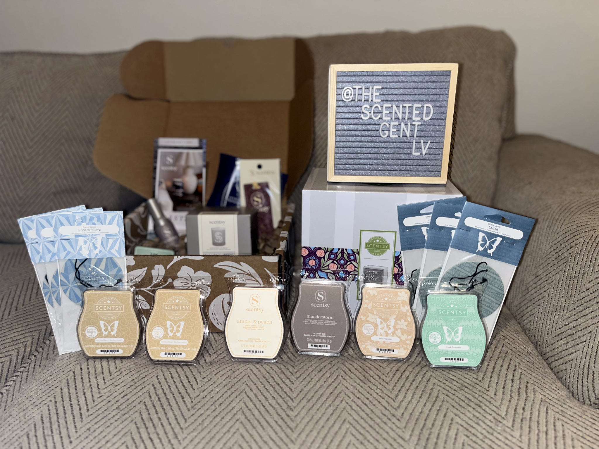 A selection of Scentsy fragrance products displayed with The Scented Gent LV sign